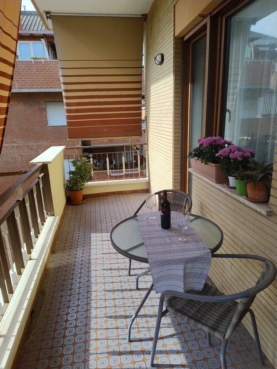 Terrace with table, two chairs and sun awning