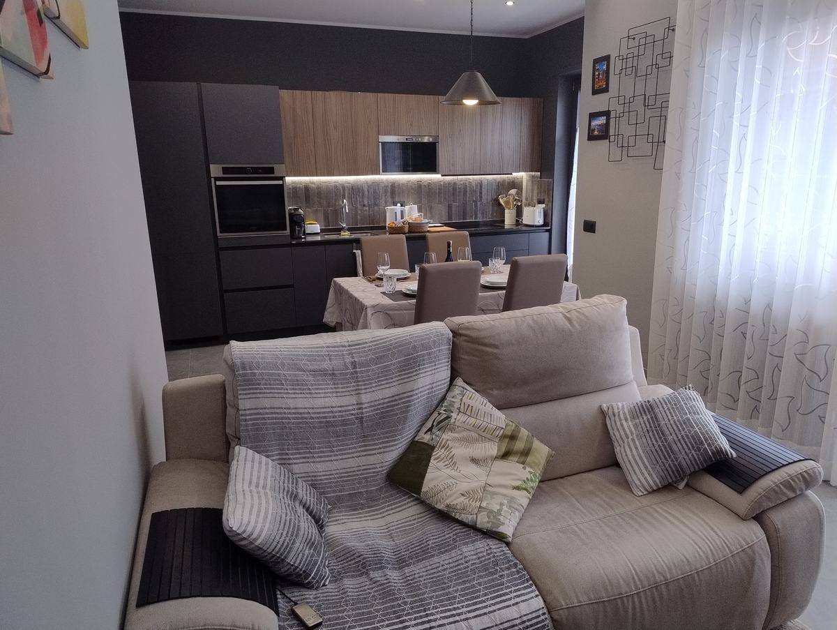 Living room sofa with kitchen behind